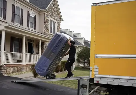 FLYT Moving crew loading a wooded single-family home near the private lake on Waterway Drive in Montclair, VA