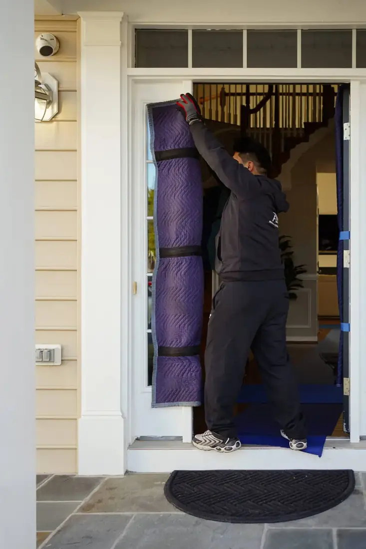 FLYT Moving crew unloading a truck in a Kentlands alley behind a townhome in Gaithersburg, MD
