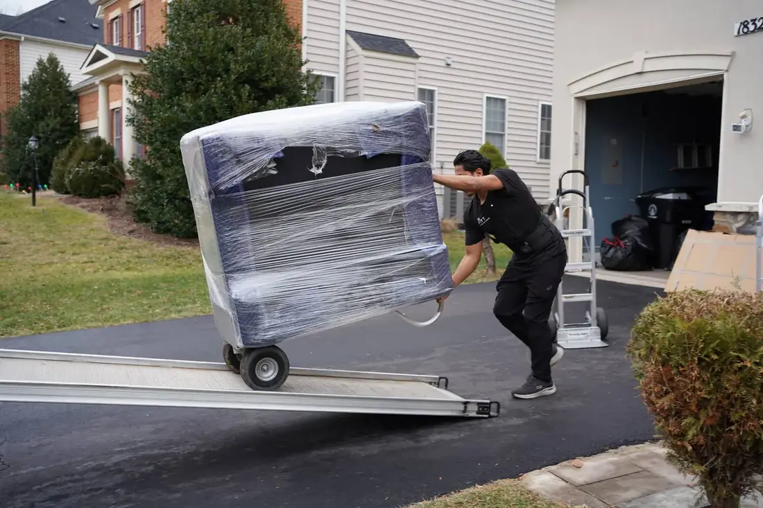 FLYT Moving crew carefully wrapping furniture at a McLean, VA estate near Langley