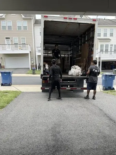 FLYT Moving crew loading a wooded townhome near Tackett's Mill by the Occoquan Reservoir in Lake Ridge, VA