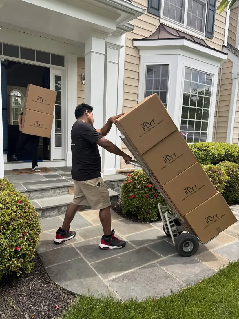 FLYT Moving crew loading a Reston Town Center high-rise freight elevator in Reston, VA